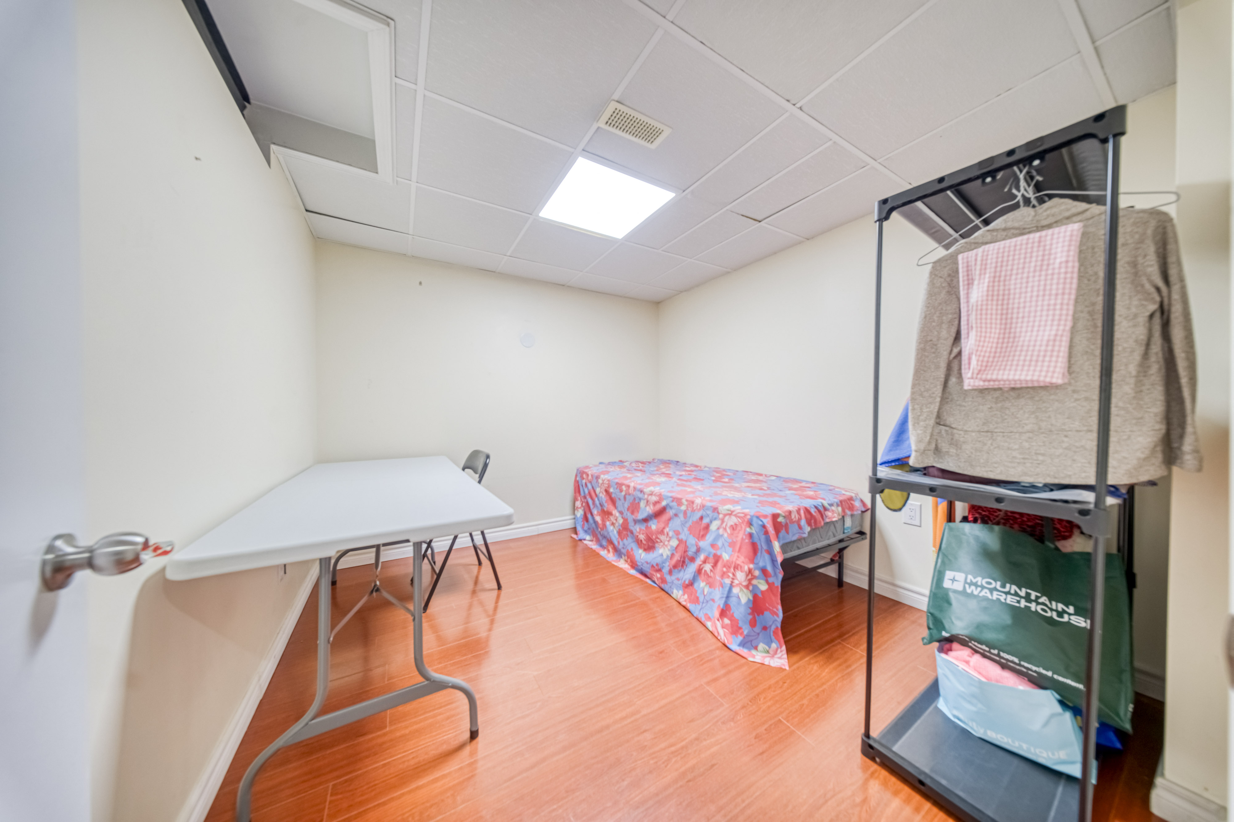 Basement Room with Desk & Storage Rack